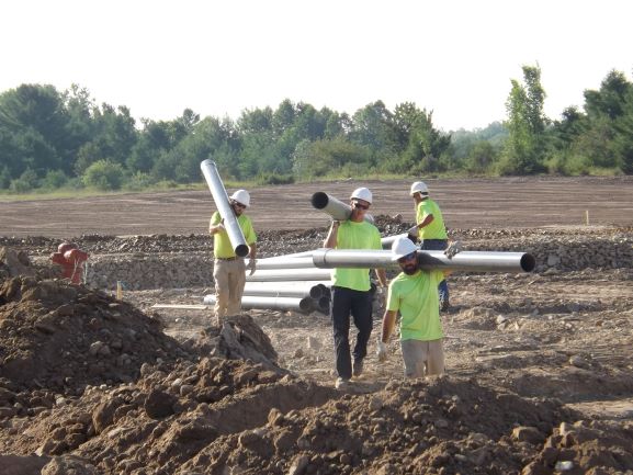 PIE&G crews carrying conduit for underground utilities