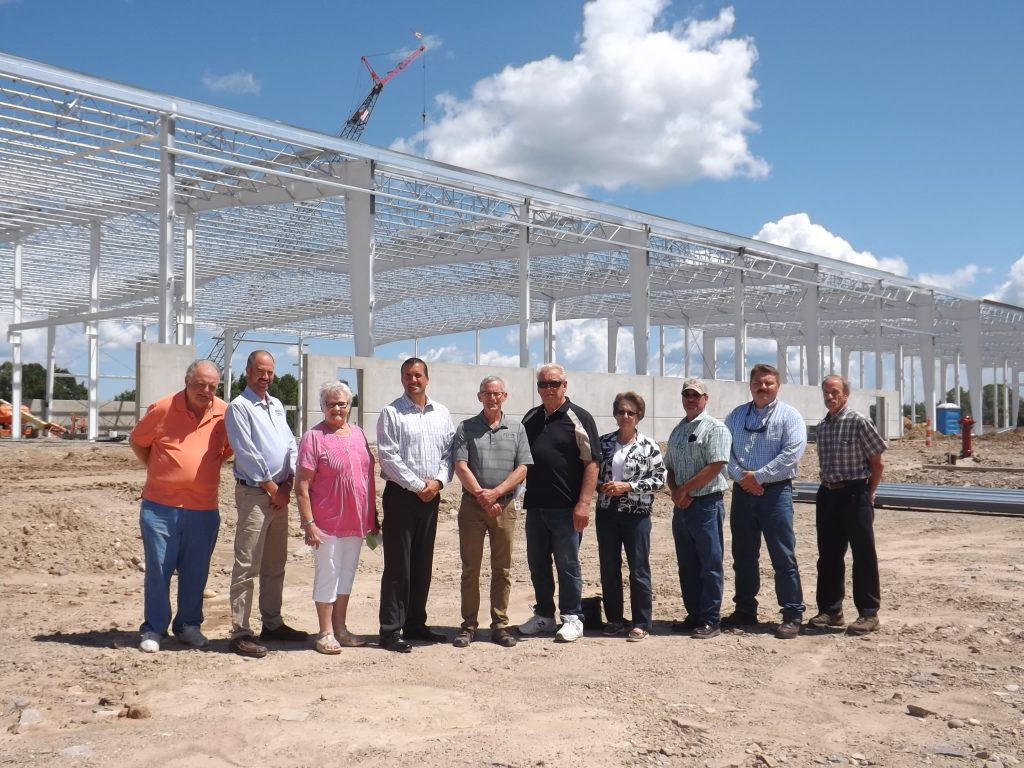 Group Photo of Directors and CEO with Steel Building Framework in back
