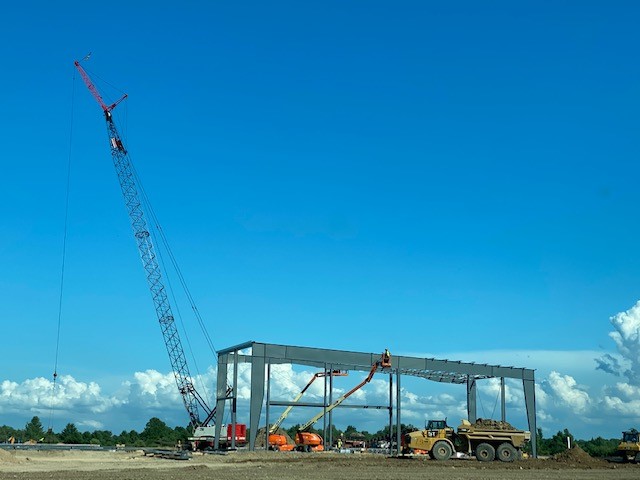 Wide angle photo of crane and new steel framework